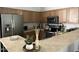 Bright kitchen features stainless steel refrigerator and appliances with a stone breakfast bar at 2150 E Bell Rd # 1068, Phoenix, AZ 85022