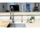 Bright kitchen features stainless steel sink and faucet with view of the adjacent living area at 2150 E Bell Rd # 1068, Phoenix, AZ 85022
