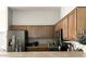 Spacious kitchen includes stainless steel appliances, wooden cabinets, and stone countertops at 2150 E Bell Rd # 1068, Phoenix, AZ 85022