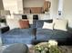 Comfortable living room featuring a plush blue sofa, decorative pillows, and an open layout to the kitchen at 2150 E Bell Rd # 1068, Phoenix, AZ 85022