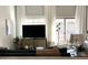 Cozy living room featuring a large TV, comfortable seating, and elegant curtains for added privacy at 2150 E Bell Rd # 1068, Phoenix, AZ 85022