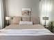 Comfortable bedroom with king bed, neutral bedding, decorative pillows, and side table lamps at 2150 E Bell Rd # 1068, Phoenix, AZ 85022