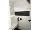 Detailed shot of a walk-in shower with built-in bench, black tile niche, and modern fixtures at 2150 E Bell Rd # 1068, Phoenix, AZ 85022