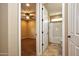A bedroom and bathroom are connected with neutral colors and a ceiling fan at 21883 N 263Rd Dr, Buckeye, AZ 85396