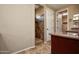 Bathroom with a tiled shower, wood cabinets, and access to the walk in closet at 21883 N 263Rd Dr, Buckeye, AZ 85396