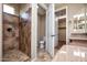 Updated bathroom featuring tiled walk-in shower, granite countertops and an attached walk-in closet at 21883 N 263Rd Dr, Buckeye, AZ 85396