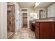 Bathroom with a tiled shower, double vanity, and door to the walk in closet at 21883 N 263Rd Dr, Buckeye, AZ 85396