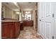 Spacious bathroom with and vanities, tiled floors, and neutral paint tones throughout at 21883 N 263Rd Dr, Buckeye, AZ 85396