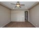 Spacious bedroom featuring neutral color palette, carpet, ceiling fan and an arched doorway at 21883 N 263Rd Dr, Buckeye, AZ 85396