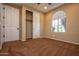 A neutral colored bedroom with a ceiling fan, closet and window at 21883 N 263Rd Dr, Buckeye, AZ 85396