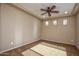 This inviting bedroom features a ceiling fan, neutral walls, and carpet flooring at 21883 N 263Rd Dr, Buckeye, AZ 85396