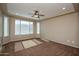 Empty bedroom with neutral paint, carpet, a ceiling fan, and a window allowing for natural light at 21883 N 263Rd Dr, Buckeye, AZ 85396