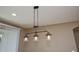 Close up of a chandelier with Edison style bulbs hanging from the ceiling at 21883 N 263Rd Dr, Buckeye, AZ 85396