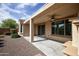 Extended covered patio with ceiling fan and ample space for outdoor seating and entertaining at 21883 N 263Rd Dr, Buckeye, AZ 85396