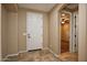Neutral foyer featuring tile flooring, leading to various rooms in the house at 21883 N 263Rd Dr, Buckeye, AZ 85396