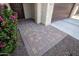Inviting front entrance with a beautiful paver walkway and lush greenery enhancing the curb appeal at 21883 N 263Rd Dr, Buckeye, AZ 85396