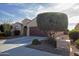 Attractive home with desert landscaping and a long driveway leading to the attached garage at 21883 N 263Rd Dr, Buckeye, AZ 85396