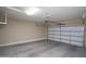 Empty garage with a clean concrete floor and white garage door, ready for customization at 21883 N 263Rd Dr, Buckeye, AZ 85396