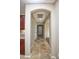 Arched hallway with beautiful tile flooring leading to the home's entrance at 21883 N 263Rd Dr, Buckeye, AZ 85396