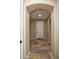 Hallway with tile flooring and neutral paint, leading to various rooms within the home at 21883 N 263Rd Dr, Buckeye, AZ 85396