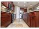 Modern kitchen with stainless steel appliances, granite counters, and rich wood cabinetry at 21883 N 263Rd Dr, Buckeye, AZ 85396