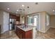 Open kitchen with stainless steel appliances, granite countertops, and eat-in breakfast bar at 21883 N 263Rd Dr, Buckeye, AZ 85396