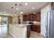 Bright kitchen with stainless appliances, granite countertops, and backyard access at 21883 N 263Rd Dr, Buckeye, AZ 85396