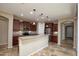 This kitchen boasts stainless steel appliances, granite countertops, and a center island at 21883 N 263Rd Dr, Buckeye, AZ 85396