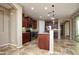 Well-lit kitchen featuring stainless appliances, granite counters, and custom cabinets at 21883 N 263Rd Dr, Buckeye, AZ 85396