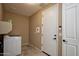 Bright laundry room featuring a modern washer and dryer, a door and keypad access at 21883 N 263Rd Dr, Buckeye, AZ 85396