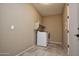 Bright laundry room with modern washer and dryer, shelving for storage, and tiled floor at 21883 N 263Rd Dr, Buckeye, AZ 85396