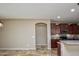 View of the kitchen from the living room, with tile flooring and neutral colored walls at 21883 N 263Rd Dr, Buckeye, AZ 85396