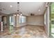 Open-concept living area with tile flooring, ceiling fan, and access to the outdoor space at 21883 N 263Rd Dr, Buckeye, AZ 85396