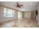 Open living room featuring tile floors, a ceiling fan and sliding door access to the outdoors at 21883 N 263Rd Dr, Buckeye, AZ 85396
