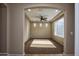 Inviting living room features three small windows and a ceiling fan at 21883 N 263Rd Dr, Buckeye, AZ 85396