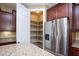 Bright kitchen with stainless fridge and walk-in pantry at 21883 N 263Rd Dr, Buckeye, AZ 85396