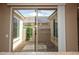 The patio is viewed through the living space at 21883 N 263Rd Dr, Buckeye, AZ 85396
