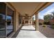 Covered patio with a cozy fireplace and access to a landscaped yard with gravel at 21883 N 263Rd Dr, Buckeye, AZ 85396