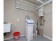 Functional utility room with a water softener and shelving system for organization at 21883 N 263Rd Dr, Buckeye, AZ 85396