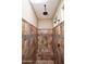 Tiled walk-in shower features rain style shower head and two shower heads, as well as built in bench at 21883 N 263Rd Dr, Buckeye, AZ 85396