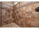 Close up of tiled walk-in shower with built in shower niche and a tile patterned border at 21883 N 263Rd Dr, Buckeye, AZ 85396
