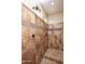 Tiled walk-in shower featuring two shower heads, tile patterned border, and two windows at 21883 N 263Rd Dr, Buckeye, AZ 85396