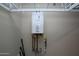 Efficient, modern, wall-mounted tankless hot water heater in utility area at 21883 N 263Rd Dr, Buckeye, AZ 85396