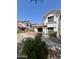 Community homes feature stucco exteriors, brick fencing around the front patio and desert landscaping at 2201 N Comanche Dr # 1093, Chandler, AZ 85224