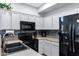 Bright kitchen featuring gray cabinetry, tile backsplash, and modern appliances at 2201 N Comanche Dr # 1093, Chandler, AZ 85224