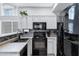 Contemporary kitchen featuring gray cabinets, a modern backsplash, and stainless-steel appliances at 2201 N Comanche Dr # 1093, Chandler, AZ 85224