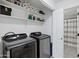 Convenient laundry room featuring modern, high-efficiency washer and dryer with direct bathroom access at 2201 N Comanche Dr # 1093, Chandler, AZ 85224