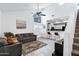 Bright living room featuring high ceilings, ceiling fan, and an open floor plan connecting to the kitchen at 2201 N Comanche Dr # 1093, Chandler, AZ 85224
