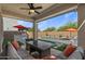 A cozy back patio featuring a fire pit, outdoor seating, and a view of the pool at 22136 N 28Th Pl, Phoenix, AZ 85050
