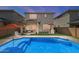 Stunning backyard with a sparkling pool, covered patio area, complete with lounge seating, and an outdoor kitchen at 22136 N 28Th Pl, Phoenix, AZ 85050
